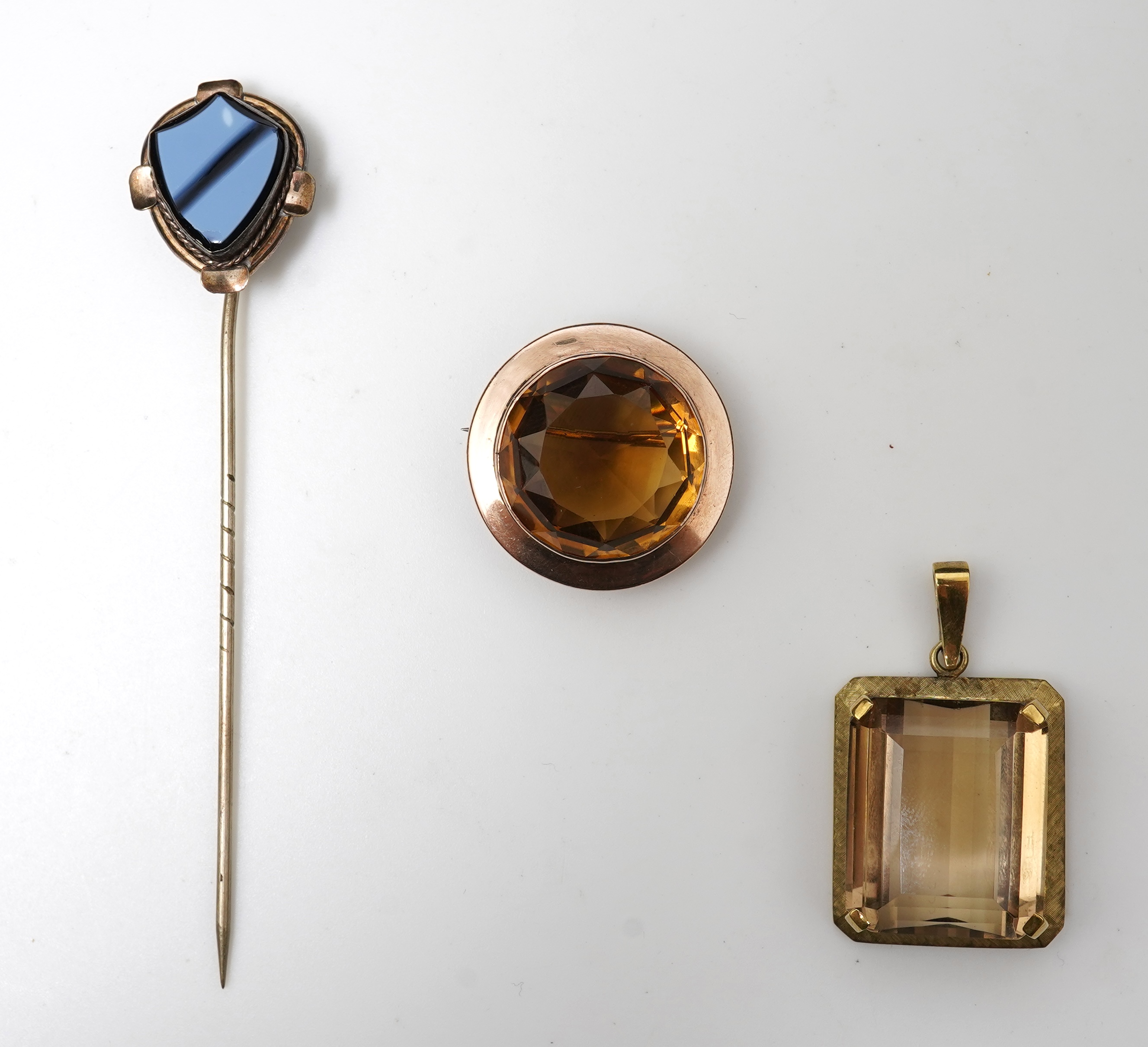 A citrine brooch and pendant, and onyx stickpin
